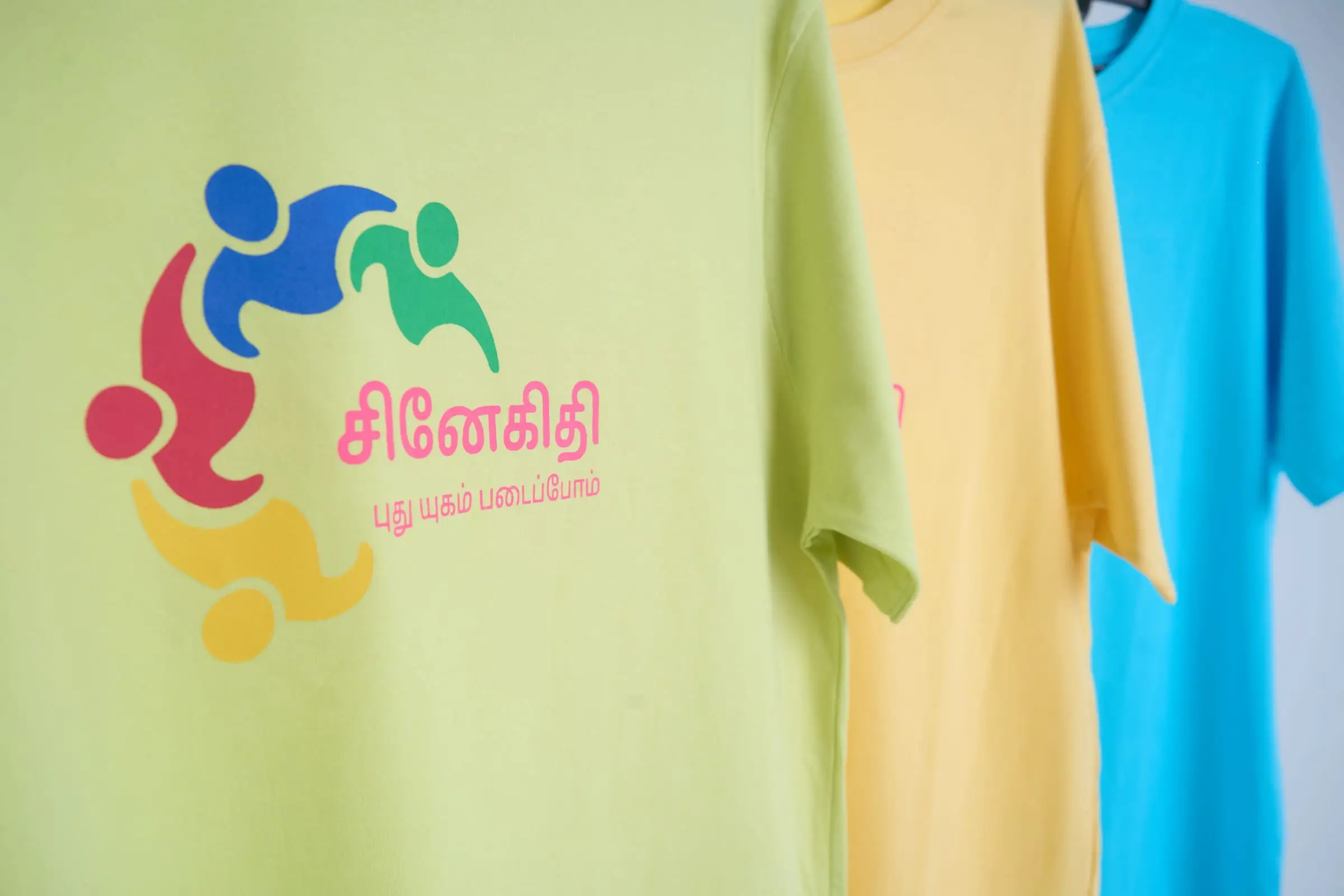 The finished print close up on a green t-shirt, the same artwork carried through the yellow and blue of the run.