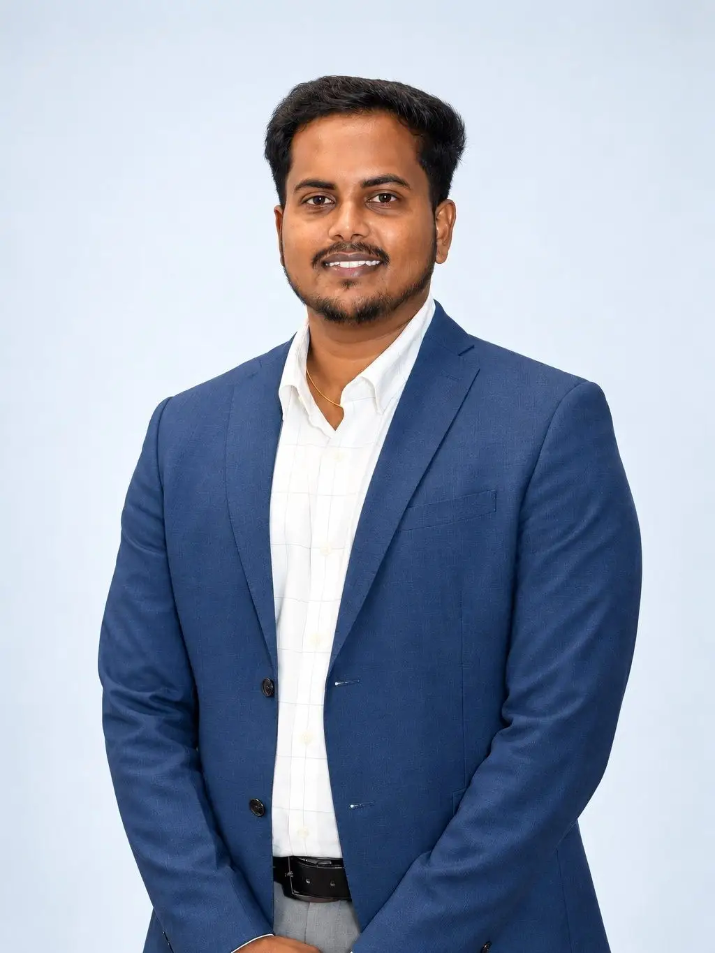 Rakesh Kishen U, founder of Trend Trade, in a navy blazer and white shirt against a plain studio backdrop.