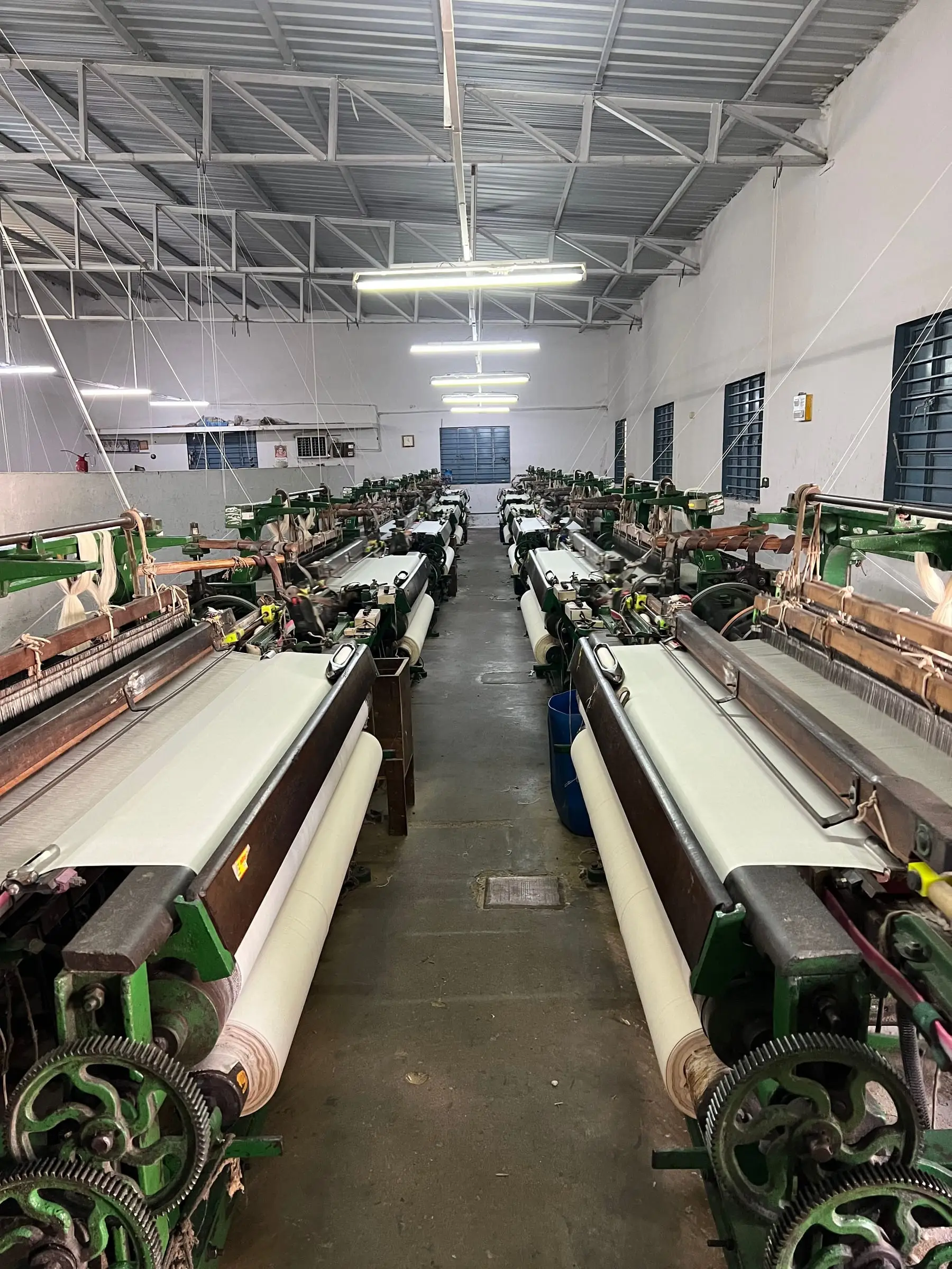 The knitting hall end to end, machine after machine running under the skylights.