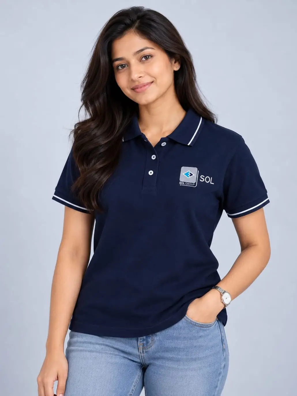 A model in the women's fit of the navy SOL polo, white-tipped collar and cuffs, the logo embroidered at the chest.