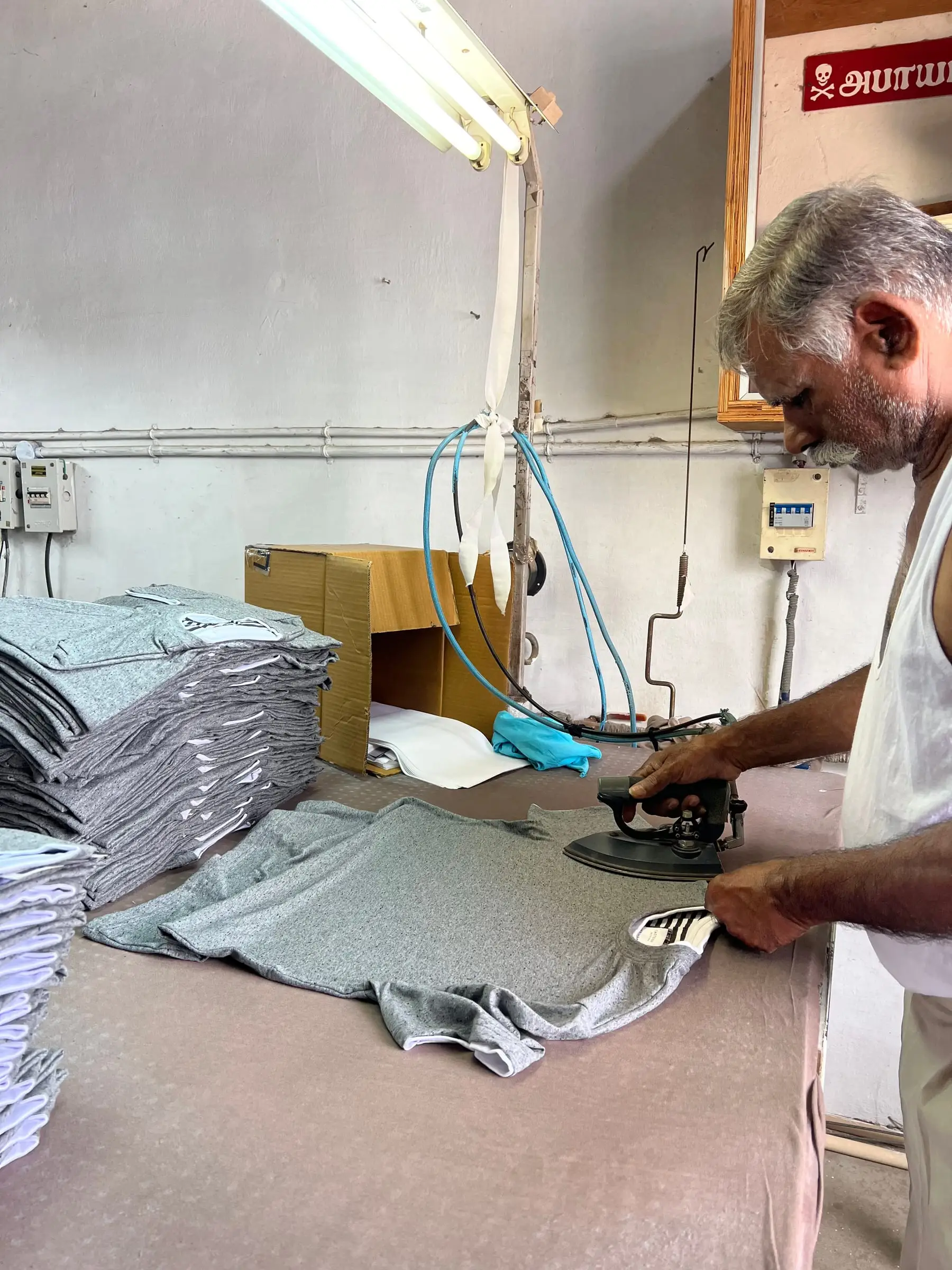A garment being pressed and finished before it goes forward for inspection.